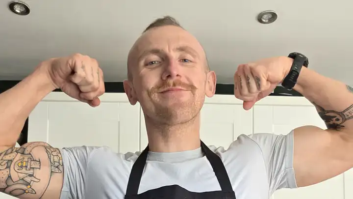 Dr Tom flexing in his kitchen